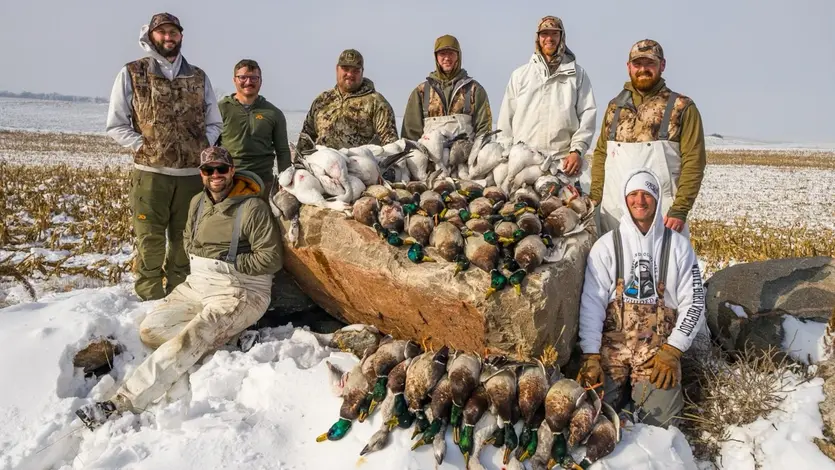 group of guys duck hunting in a field